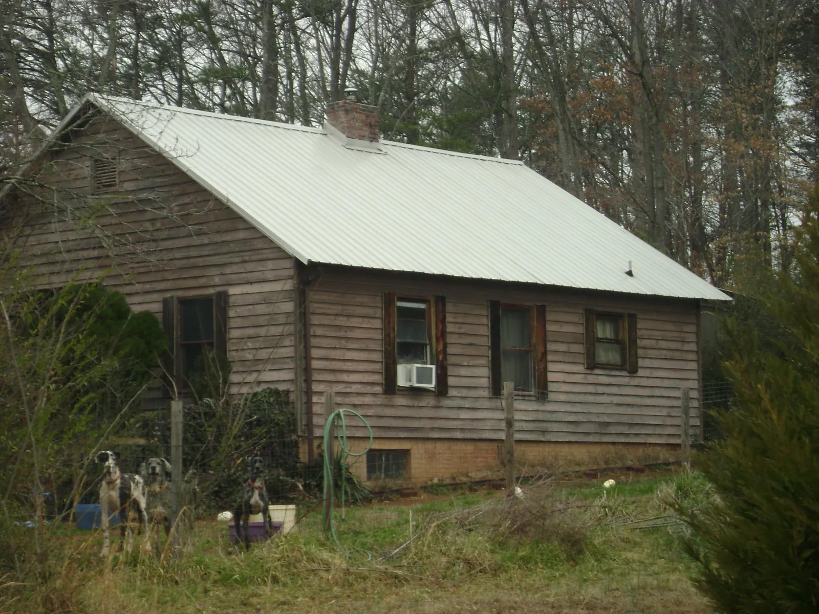White metal roof on an old wood sided farmhouse, from a Metal Roof Installation job in Keezletown